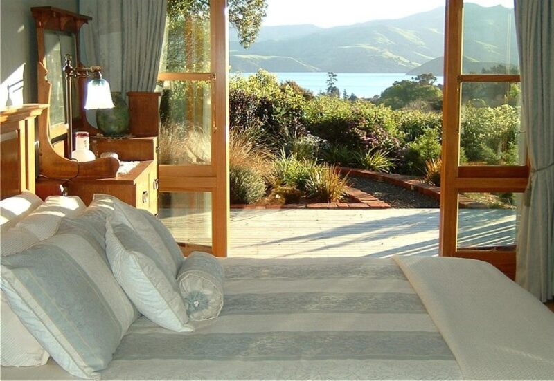 New Zealand boutique lodge bedroom with harbour and mountain views