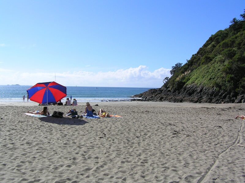 Beach goers on Waiheke Island Auckland New Zealand