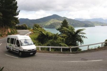 Campervan on a winding coastal road through the Marlborough Sounds New Zealand