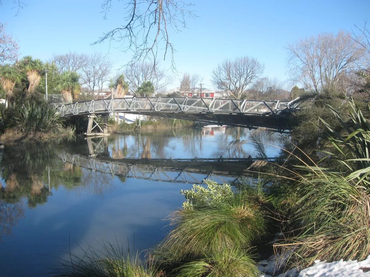 Medway footbridge over the Avon River in the Christchurch earthquake red zone with native plantings and reflections