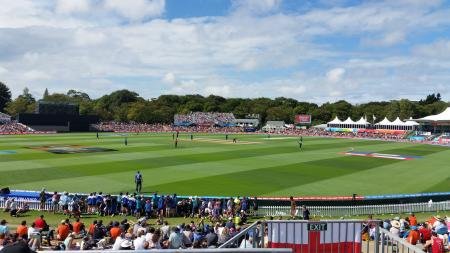 Hagley Oval cricket ground Christchurch with crowd and Hagley Park trees
