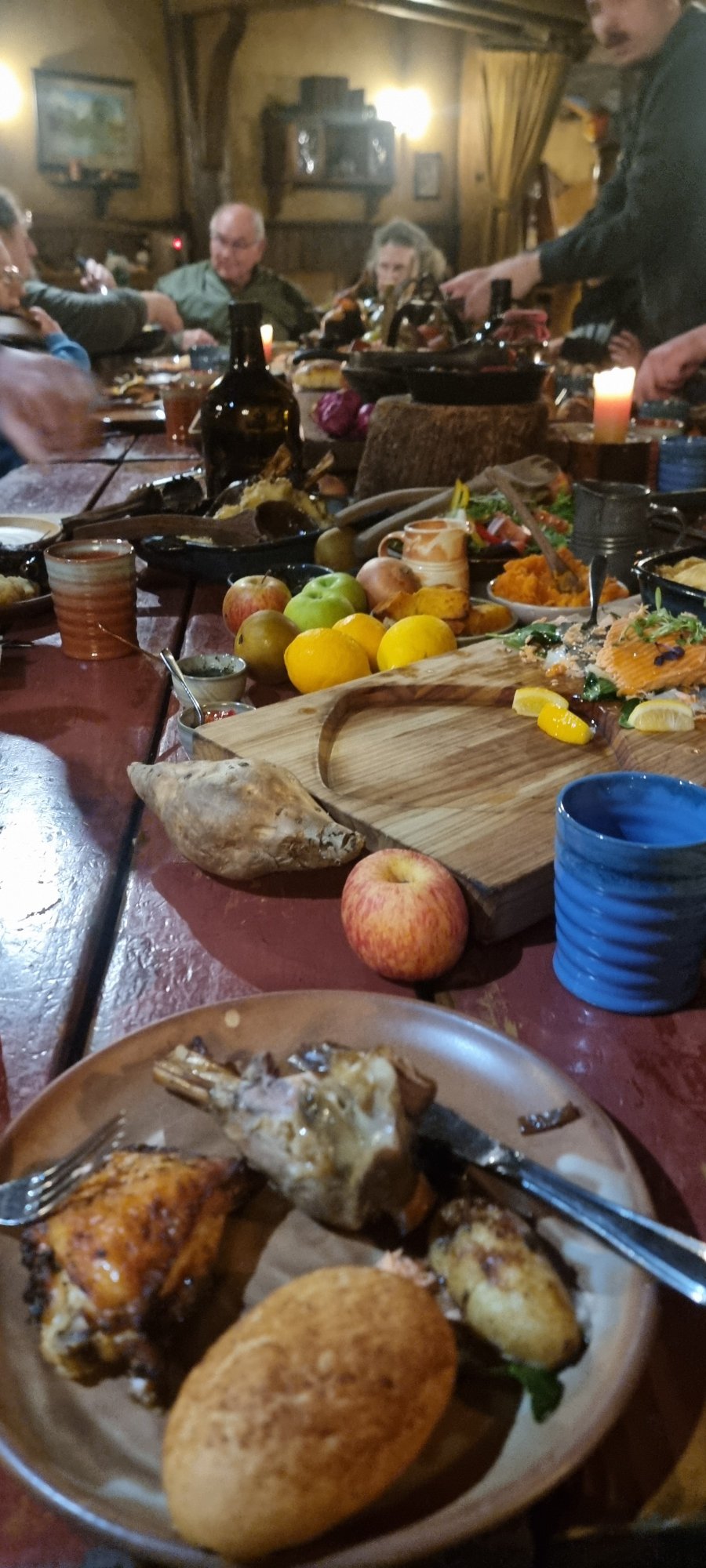 Evening Banquet feast inside the Green Dragon Inn at Hobbiton with roast meats, bread and Southfarthing ales