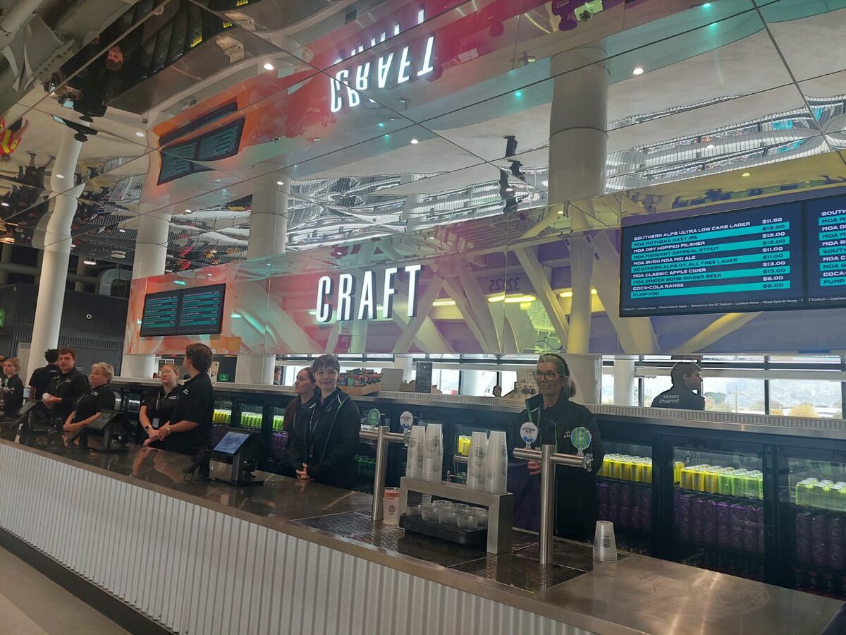 Craft beer bar inside One NZ Stadium Te Kaha showing Southern Alps and Moa taps with prices
