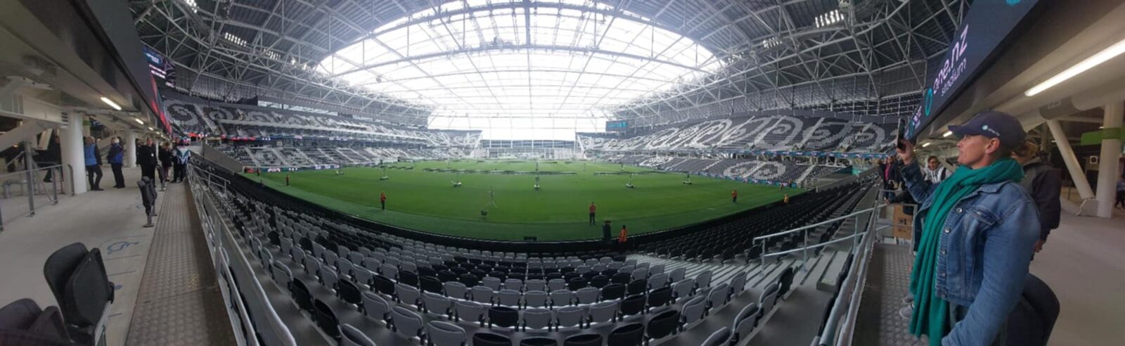 Panoramic interior view of One NZ Stadium Te Kaha showing steep seating bowl, pitch and ETFE roof