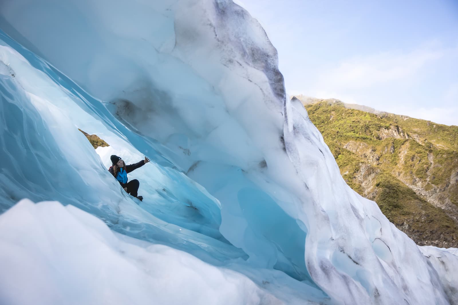 Tour group dwarfed by massive Fox Glacier ice field West Coast New Zealand