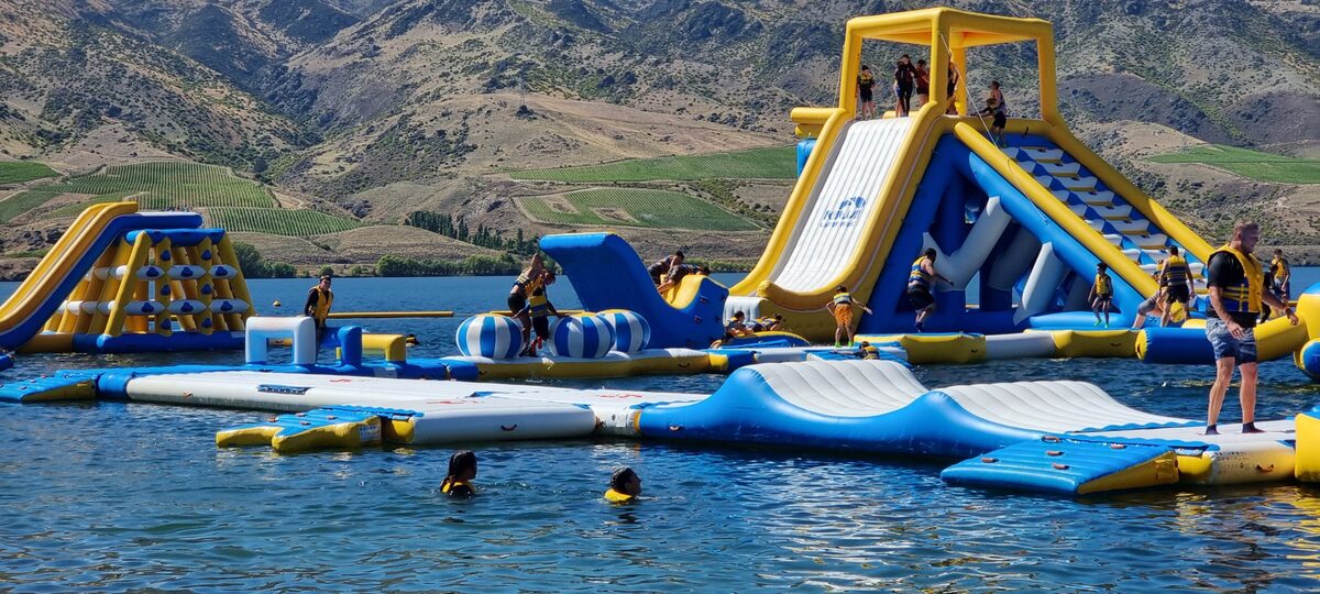 Inflatable waterpark on Lake Dunstan near Cromwell with mountains Central Otago New Zealand