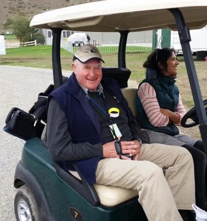 Sir Tim Wallis founder of Warbirds Over Wanaka airshow in a golf cart at Wanaka Airport