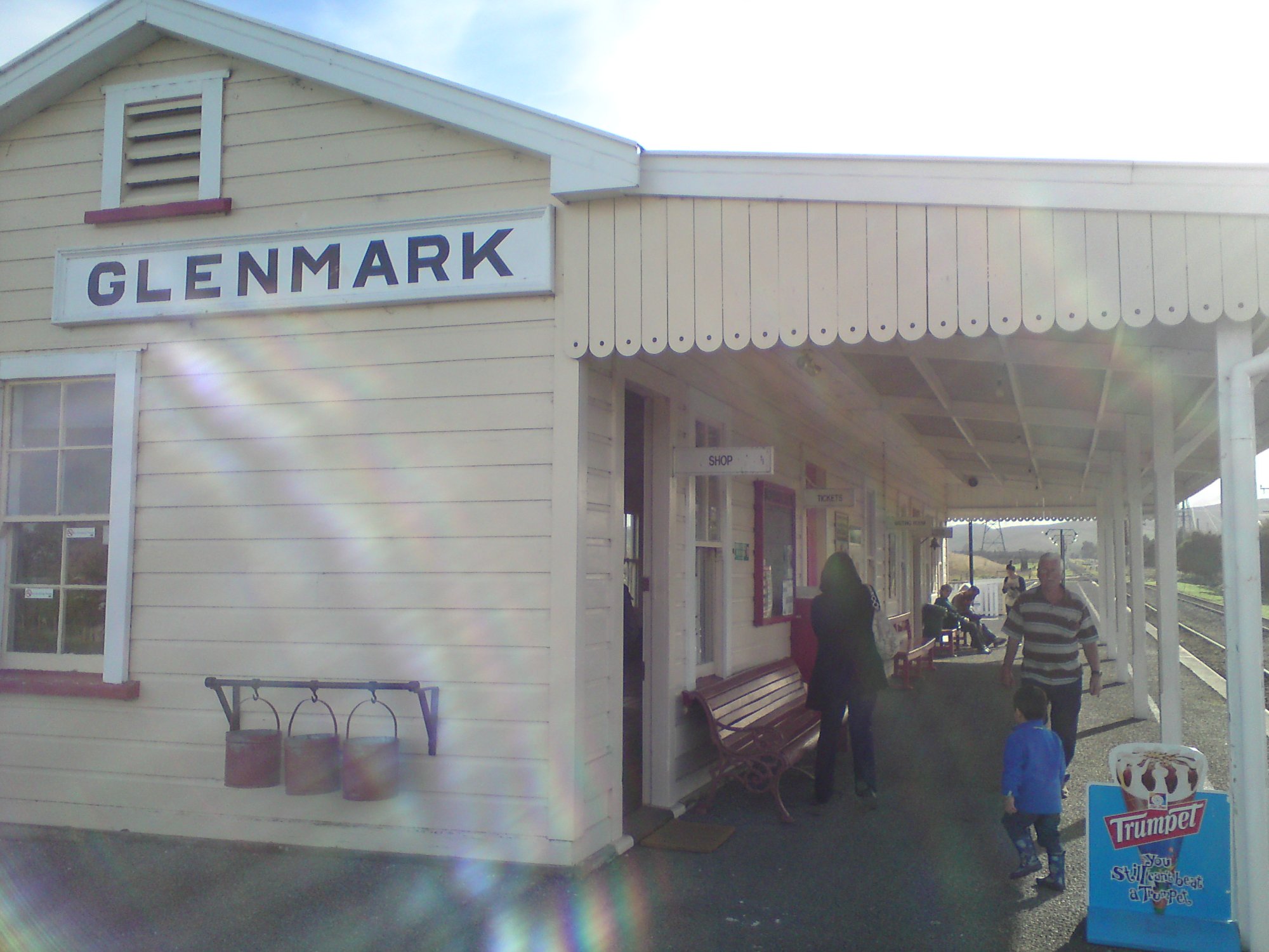 Glenmark Station exterior with platform and visitors on a sunny day
